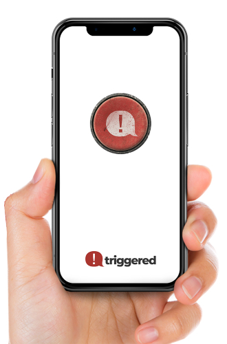 Hand holding a phone with the Triggered app